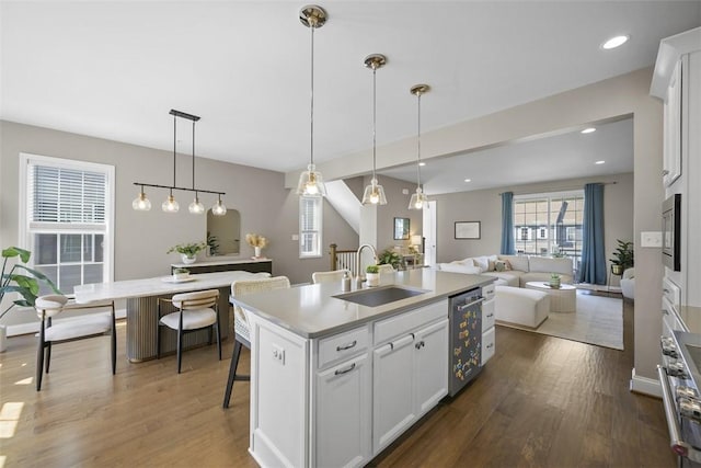 2123 Westcott Ln, South Fayette, PA 15017 - kitchen featuring appliances with stainless steel finishes, a center island with sink, wood finished floors, white cabinets, and recessed lighting