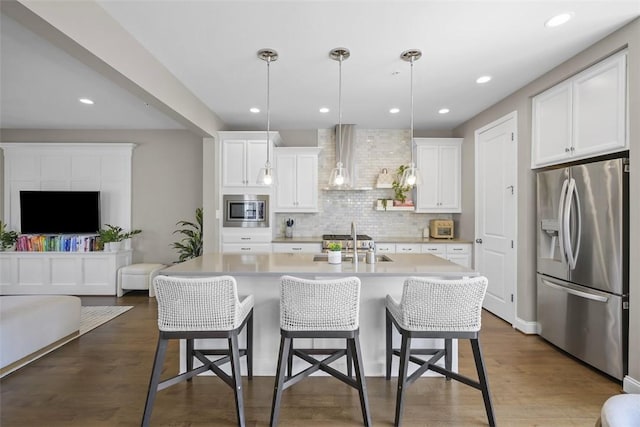 2123 Westcott Ln, South Fayette, PA 15017 - kitchen with appliances with stainless steel finishes, light countertops, tasteful backsplash, wall chimney exhaust hood, and white cabinetry