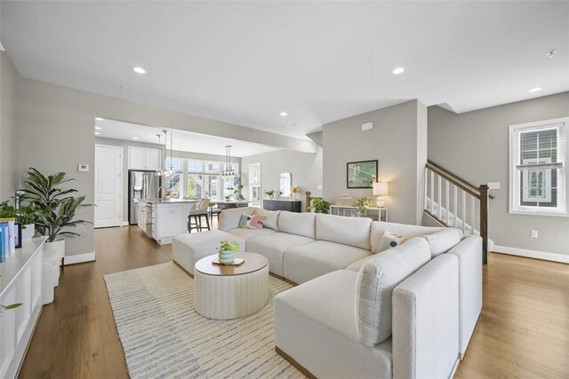 2123 Westcott Ln, South Fayette, PA 15017 - living area featuring wood finished floors, recessed lighting, stairway, and a chandelier