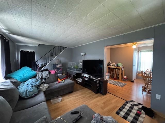 909 N Hickory St, Scottdale, PA 15685 - living room featuring wood finished floors and stairs