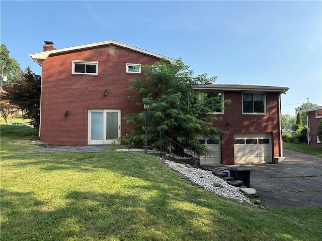 111 Hemlock Ln, Monroeville, PA 15146 - rear view of property featuring driveway, an attached garage, a chimney, and brick siding