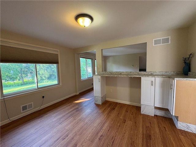 111 Hemlock Ln, Monroeville, PA 15146 - kitchen featuring light wood-style flooring and white cabinets