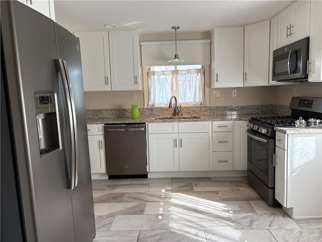 111 Hemlock Ln, Monroeville, PA 15146 - kitchen featuring appliances with stainless steel finishes, white cabinets, light stone countertops, and hanging light fixtures