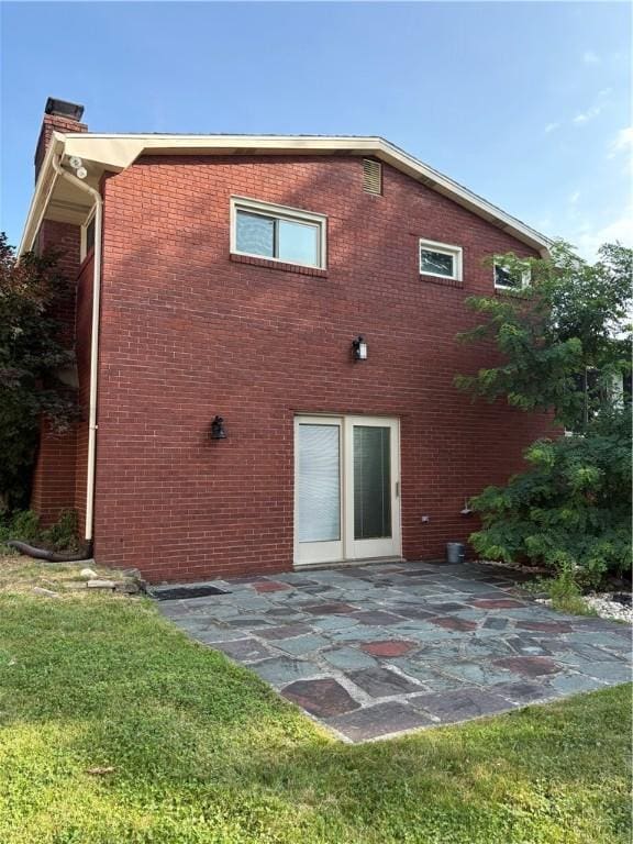 111 Hemlock Ln, Monroeville, PA 15146 - rear view of property with a patio area, a chimney, and brick siding