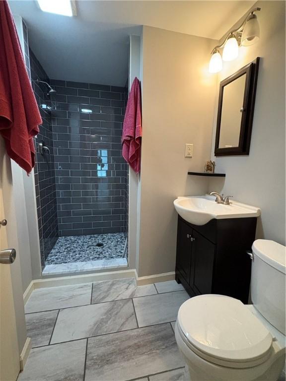 111 Hemlock Ln, Monroeville, PA 15146 - bathroom with vanity, a tile shower, and tile patterned floors