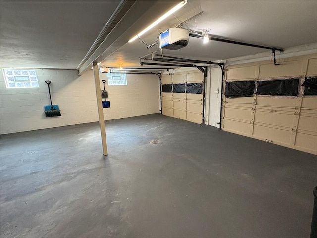 111 Hemlock Ln, Monroeville, PA 15146 - garage featuring a garage door opener and concrete block wall