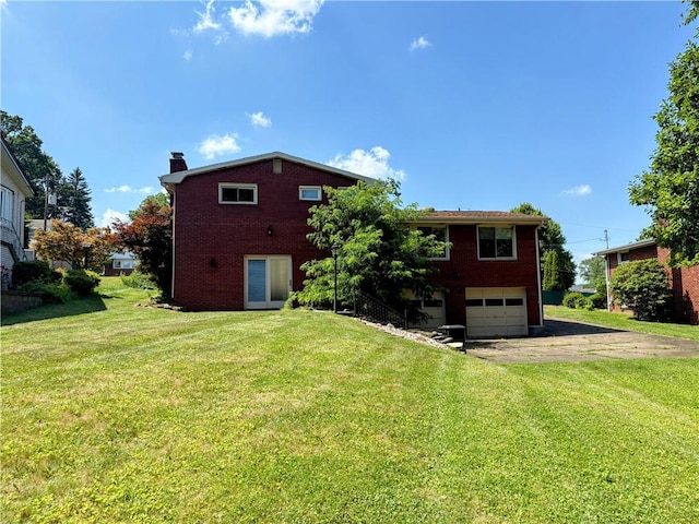111 Hemlock Ln, Monroeville, PA 15146 - back of property with asphalt driveway, brick siding, an attached garage, a chimney, and a lawn