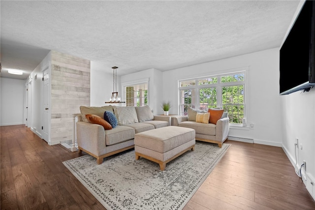 108 Heather Dr, Center Twp Bea, PA 15061 - living area with wood-type flooring, a textured ceiling, baseboard heating, and a chandelier