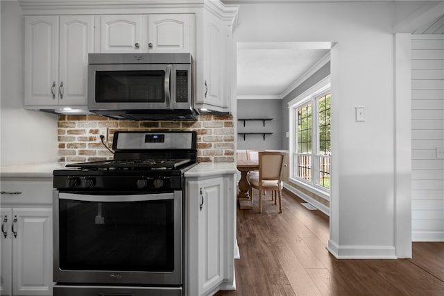 108 Heather Dr, Center Twp Bea, PA 15061 - kitchen featuring appliances with stainless steel finishes, dark wood-style flooring, decorative backsplash, white cabinetry, and ornamental molding