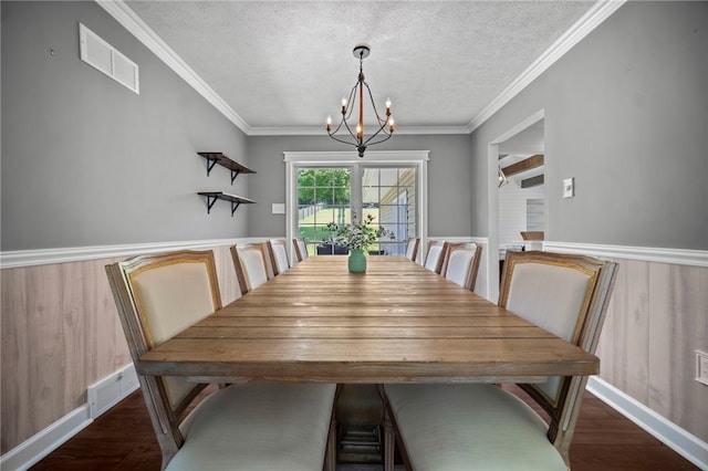 108 Heather Dr, Center Twp Bea, PA 15061 - dining area featuring a chandelier, wood finished floors, a textured ceiling, crown molding, and a wainscoted wall