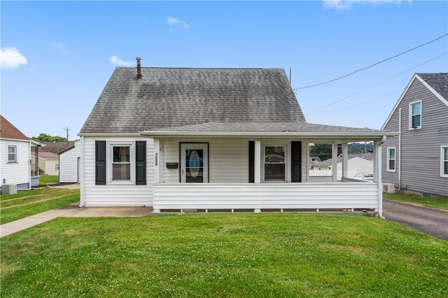 1029 Nimick Ave, Monaca, PA 15061 - view of front facade with covered porch, a front lawn, and a shingled roof
