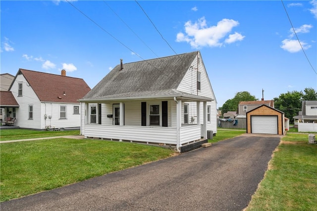 1029 Nimick Ave, Monaca, PA 15061 - cape cod home featuring an outbuilding, roof with shingles, a detached garage, and a front lawn