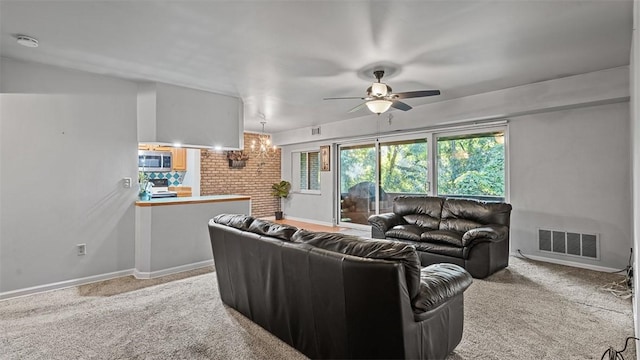 6108 Sanlin Dr, Moon/Crescent Twp, PA 15108 - carpeted living room featuring a ceiling fan and a chandelier