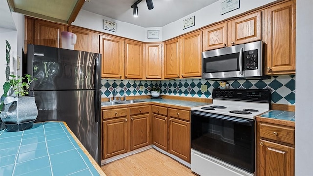6108 Sanlin Dr, Moon/Crescent Twp, PA 15108 - kitchen with stainless steel microwave, freestanding refrigerator, white range with electric cooktop, tile counters, and backsplash