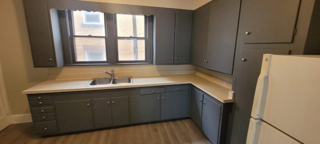304 Elm Ave, Sharon, PA 16146 - kitchen with freestanding refrigerator, gray cabinetry, light countertops, and light wood finished floors