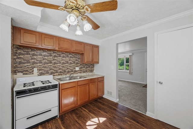 11256 Azalea Dr, Penn Hills, PA 15235 - kitchen with white gas range, light countertops, brown cabinetry, decorative backsplash, and dark wood-style flooring
