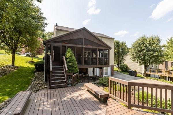 859 Boulder Dr, Bethel Park, PA 15102 - wooden deck featuring a sunroom, a lawn, and stairs