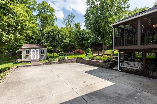 859 Boulder Dr, Bethel Park, PA 15102 - view of patio featuring a storage unit, a sunroom, and view of wooded area