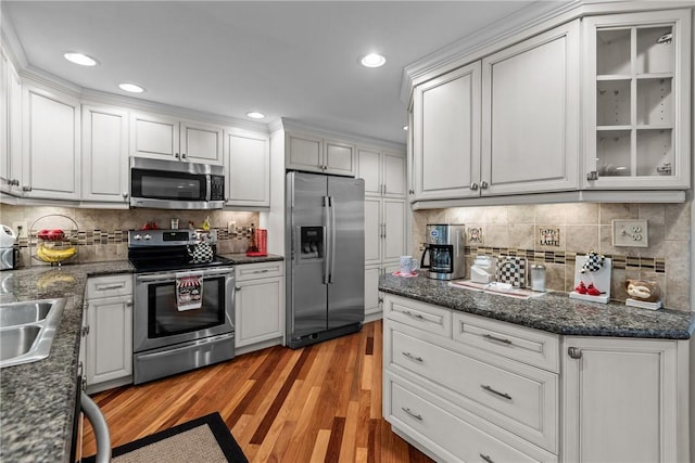 859 Boulder Dr, Bethel Park, PA 15102 - kitchen featuring appliances with stainless steel finishes, light wood-style floors, white cabinets, decorative backsplash, and recessed lighting