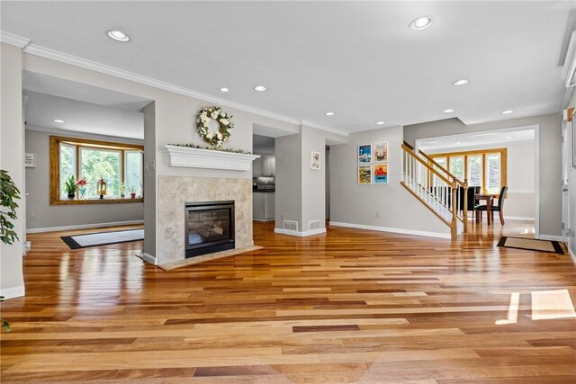 859 Boulder Dr, Bethel Park, PA 15102 - unfurnished living room with healthy amount of natural light, light wood finished floors, stairs, recessed lighting, and a fireplace