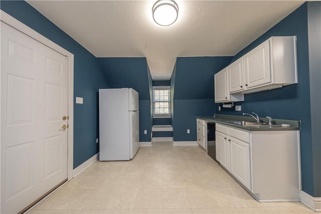 503 Sharon Rd, Moon/Crescent Twp, PA 15108 - kitchen featuring freestanding refrigerator, white cabinets, dark countertops, dishwasher, and a textured ceiling