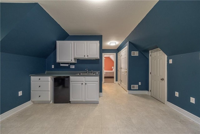 503 Sharon Rd, Moon/Crescent Twp, PA 15108 - kitchen with white cabinetry, black dishwasher, and lofted ceiling