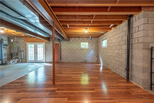 503 Sharon Rd, Moon/Crescent Twp, PA 15108 - basement with electric panel, wood finished floors, concrete block wall, and french doors