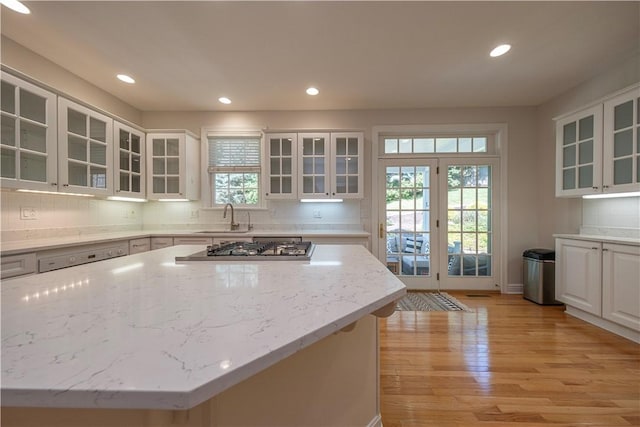 503 Sharon Rd, Moon/Crescent Twp, PA 15108 - kitchen with stainless steel gas cooktop, light wood-type flooring, recessed lighting, light stone countertops, and white cabinets