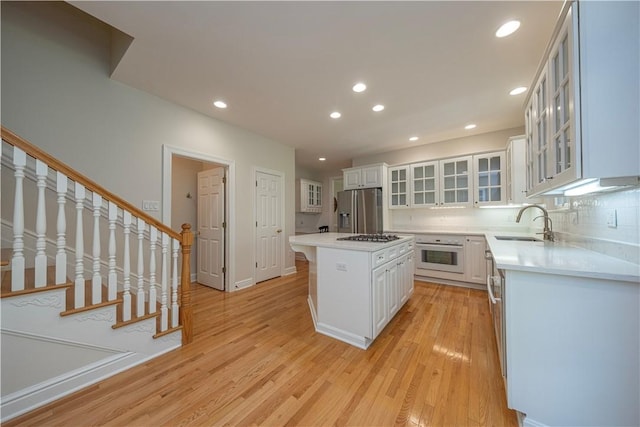 503 Sharon Rd, Moon/Crescent Twp, PA 15108 - kitchen featuring stainless steel fridge, oven, light countertops, recessed lighting, and light wood-type flooring