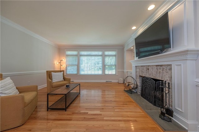 503 Sharon Rd, Moon/Crescent Twp, PA 15108 - living area featuring a brick fireplace, light wood-style floors, crown molding, and recessed lighting