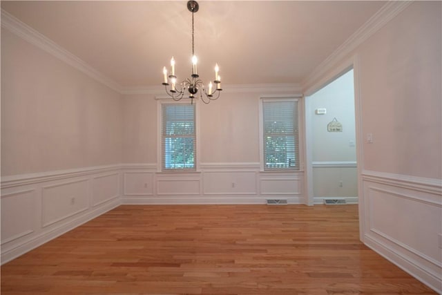 503 Sharon Rd, Moon/Crescent Twp, PA 15108 - unfurnished dining area featuring a chandelier, plenty of natural light, light wood-type flooring, crown molding, and a decorative wall