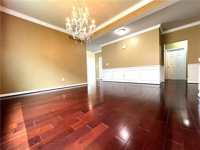 261 Patriot Ln, Economy, PA 15042 - unfurnished room with dark wood-type flooring, a chandelier, ornamental molding, wainscoting, and a decorative wall