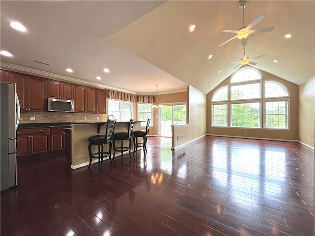 261 Patriot Ln, Economy, PA 15042 - kitchen featuring stainless steel microwave, freestanding refrigerator, ceiling fan, dark wood-style flooring, and decorative backsplash