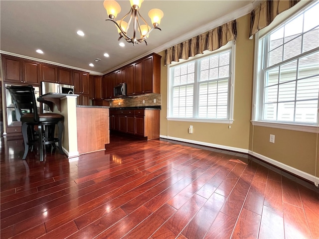 261 Patriot Ln, Economy, PA 15042 - kitchen with stainless steel microwave, a chandelier, recessed lighting, dark wood-style flooring, and hanging light fixtures