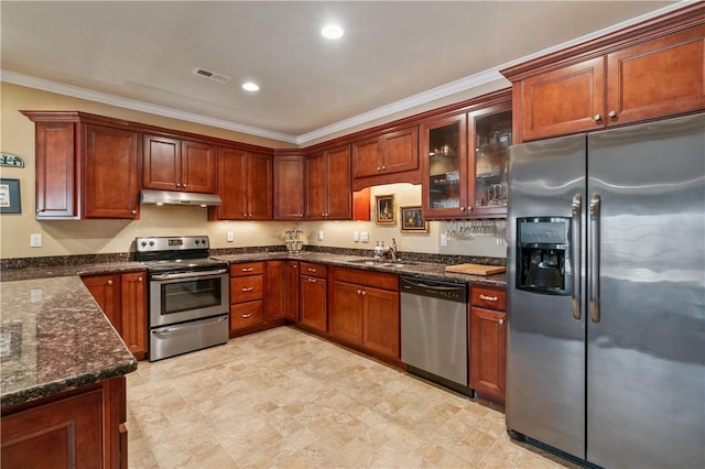 261 Patriot Ln, Economy, PA 15042 - kitchen with stainless steel appliances, under cabinet range hood, crown molding, dark stone countertops, and glass insert cabinets