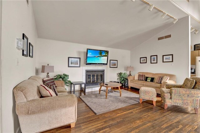 1410 Kenzie Dr, Robinson Twp, PA 15205 - living area featuring track lighting, vaulted ceiling, wood finished floors, and a fireplace