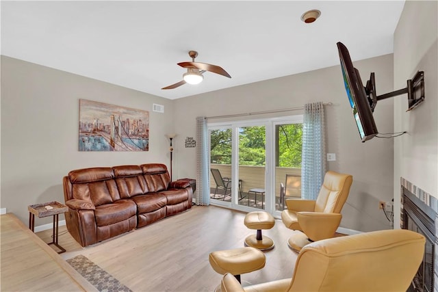 1410 Kenzie Dr, Robinson Twp, PA 15205 - living area featuring a ceiling fan, wood finished floors, and a glass covered fireplace