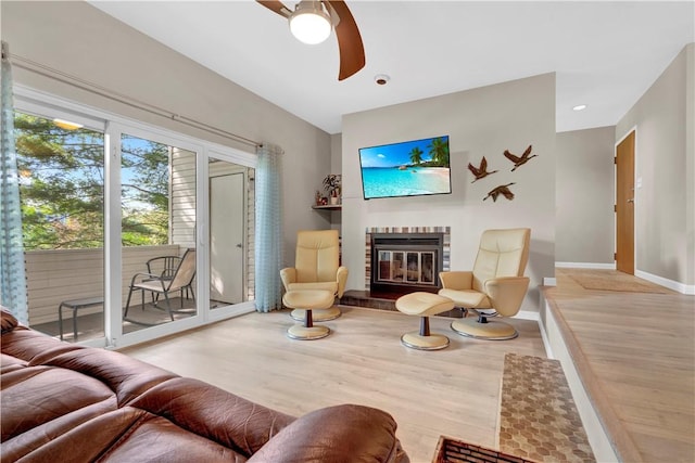 1410 Kenzie Dr, Robinson Twp, PA 15205 - living area with a ceiling fan, wood finished floors, and a glass covered fireplace