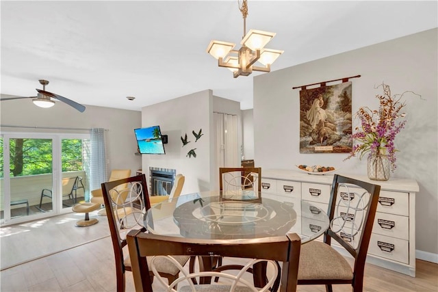1410 Kenzie Dr, Robinson Twp, PA 15205 - dining room with light wood-style flooring, ceiling fan, and a chandelier