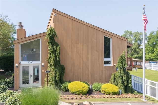 1410 Kenzie Dr, Robinson Twp, PA 15205 - view of side of property featuring a chimney and french doors
