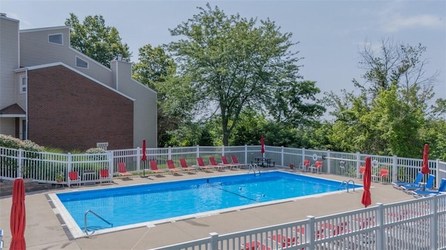 1410 Kenzie Dr, Robinson Twp, PA 15205 - community pool featuring a patio and view of wooded area
