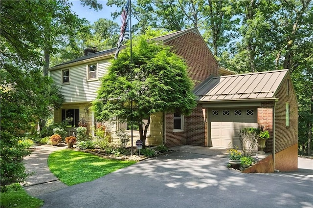 8017 Edwood Rd, Mccandless, PA 15237 - view of front of home featuring a standing seam roof, a garage, asphalt driveway, brick siding, and a metal roof