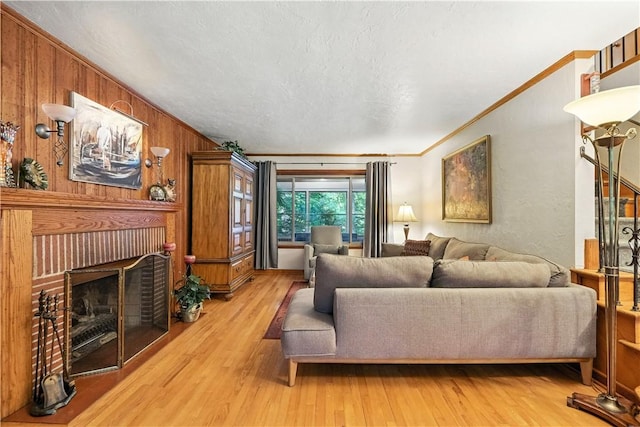 8017 Edwood Rd, Mccandless, PA 15237 - living room featuring light wood finished floors, a fireplace, ornamental molding, and wood walls
