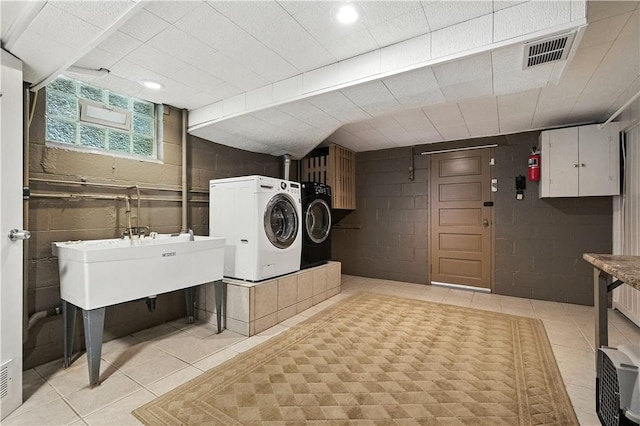 8017 Edwood Rd, Mccandless, PA 15237 - laundry area with washing machine and clothes dryer, light tile patterned flooring, cabinet space, and recessed lighting