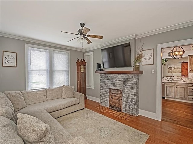 670 Sugar Camp Rd, Finleyville, PA 15332 - living area featuring ornamental molding, a fireplace, a ceiling fan, and wood finished floors