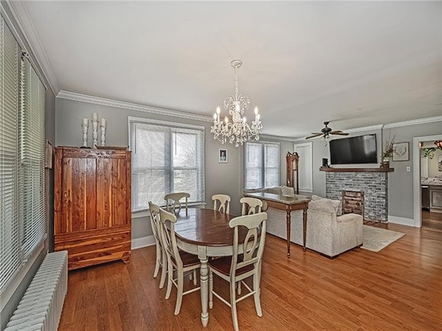 670 Sugar Camp Rd, Finleyville, PA 15332 - dining room with radiator, a fireplace, wood finished floors, ceiling fan, and ornamental molding