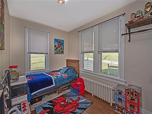 670 Sugar Camp Rd, Finleyville, PA 15332 - bedroom with radiator heating unit, multiple windows, and wood finished floors
