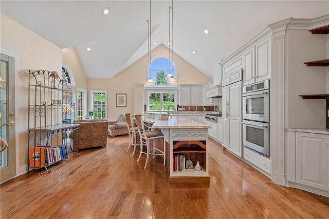 532 Salem Heights Dr, Pine Twp Nal, PA 15044 - kitchen featuring open shelves, stainless steel double oven, light wood-style floors, open floor plan, and high vaulted ceiling