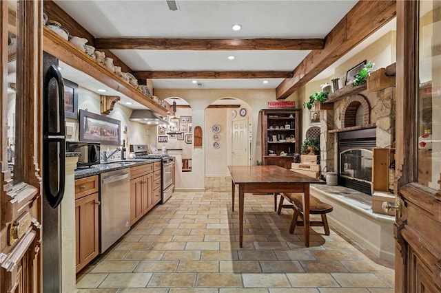 532 Salem Heights Dr, Pine Twp Nal, PA 15044 - kitchen with appliances with stainless steel finishes, arched walkways, recessed lighting, beam ceiling, and a glass covered fireplace