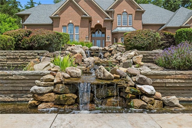 532 Salem Heights Dr, Pine Twp Nal, PA 15044 - view of front of house featuring brick siding, a shingled roof, and a small pond